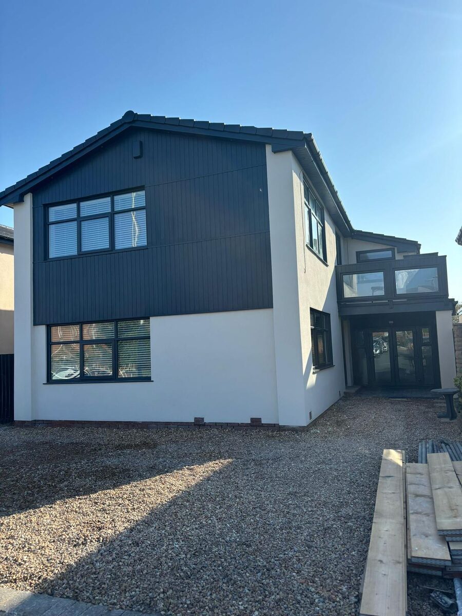 Modern house renovation with dark cladding and white render by KJ Elite Construction in Blackpool